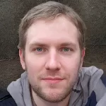 Person with short light hair and a beard, wearing a gray hoodie, representing EavesArmour's expertise in gutter maintenance and home care in Brantford, Ontario.